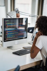 brunette woman working on a desktop pc in an office